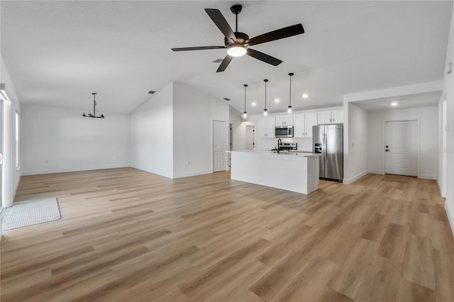 unfurnished living room with ceiling fan, light hardwood / wood-style floors, and vaulted ceiling