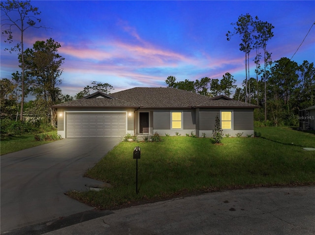 single story home with a yard and a garage