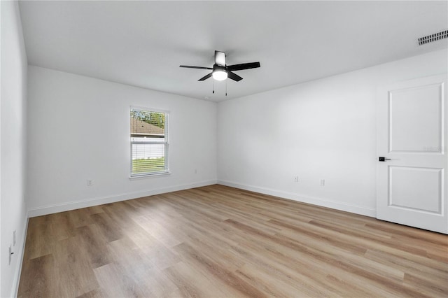 spare room featuring ceiling fan and light hardwood / wood-style flooring