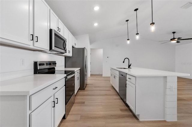 kitchen featuring hanging light fixtures, stainless steel appliances, lofted ceiling, and sink