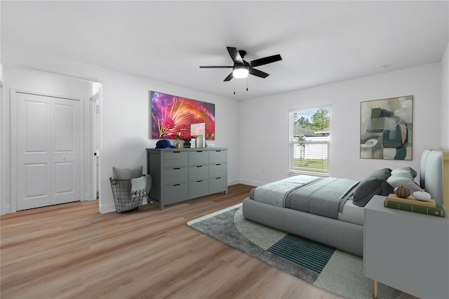 bedroom with ceiling fan, light hardwood / wood-style floors, and a closet