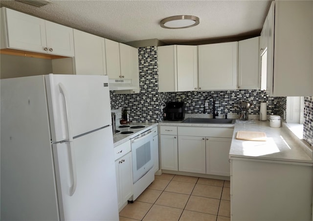 kitchen with decorative backsplash, white appliances, white cabinetry, and sink