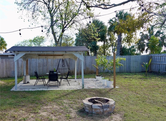 view of yard featuring a fire pit and a patio