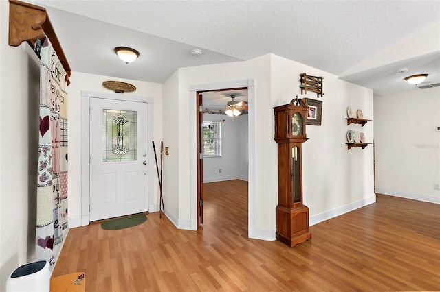 entryway featuring a textured ceiling, light hardwood / wood-style flooring, and ceiling fan