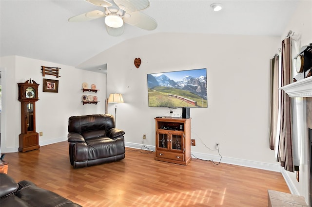 living room with hardwood / wood-style floors, ceiling fan, and lofted ceiling