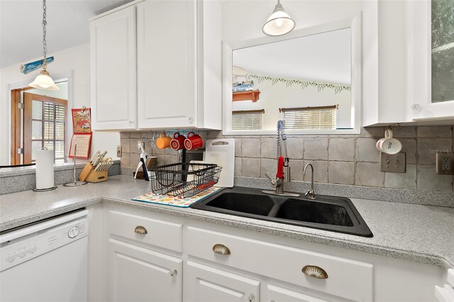 kitchen featuring backsplash, white dishwasher, white cabinetry, and sink