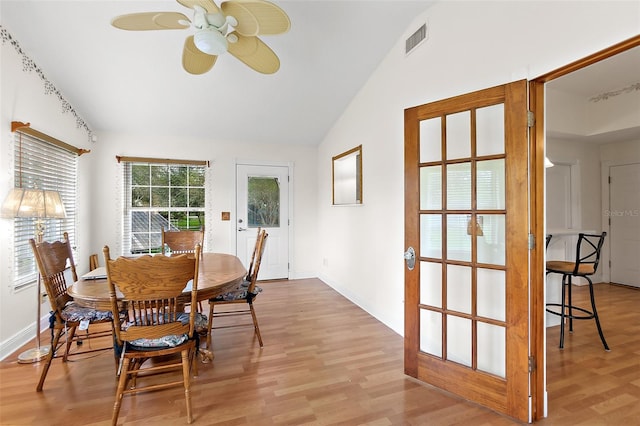 dining room featuring ceiling fan, lofted ceiling, and light wood-type flooring