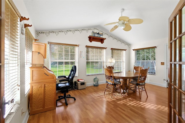 dining room with plenty of natural light, light hardwood / wood-style floors, lofted ceiling, and ceiling fan