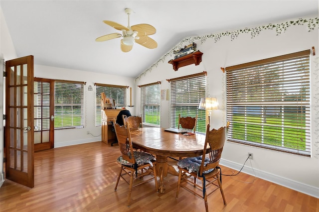 dining room featuring a wealth of natural light, hardwood / wood-style floors, ceiling fan, and lofted ceiling