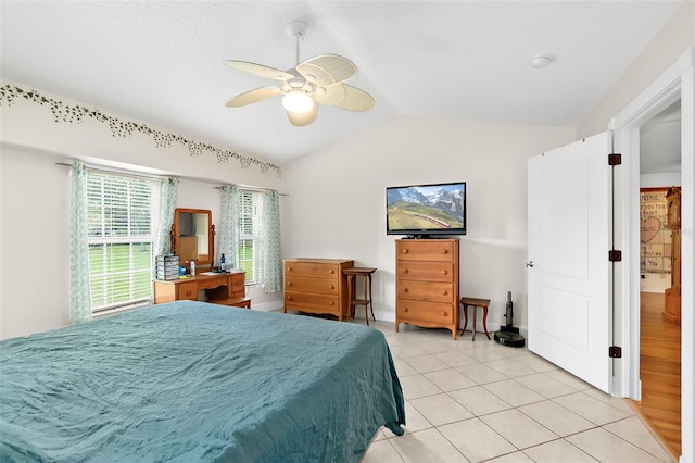 tiled bedroom featuring ceiling fan and lofted ceiling