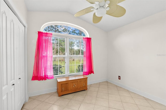 tiled spare room featuring ceiling fan and lofted ceiling