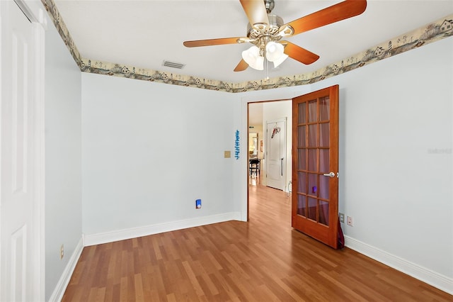 unfurnished room with ceiling fan and wood-type flooring