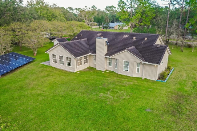 rear view of property with a yard