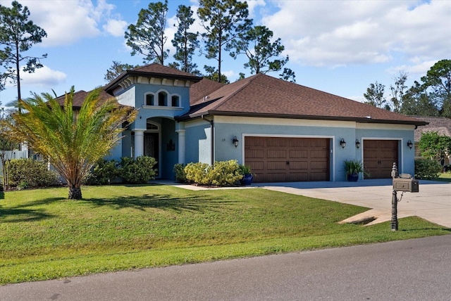 view of front facade with a front yard and a garage