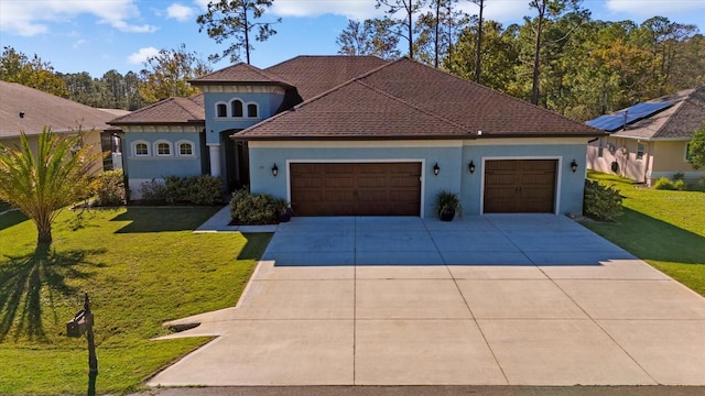 mediterranean / spanish-style house with a front lawn and a garage