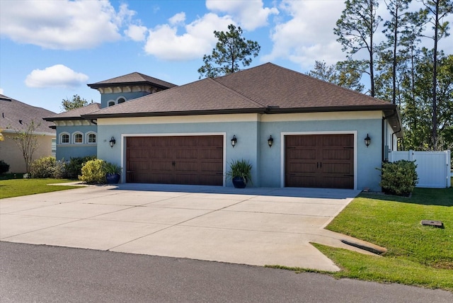 view of front facade featuring a garage and a front lawn