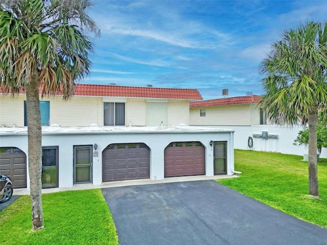 view of front of house with a garage and a front lawn