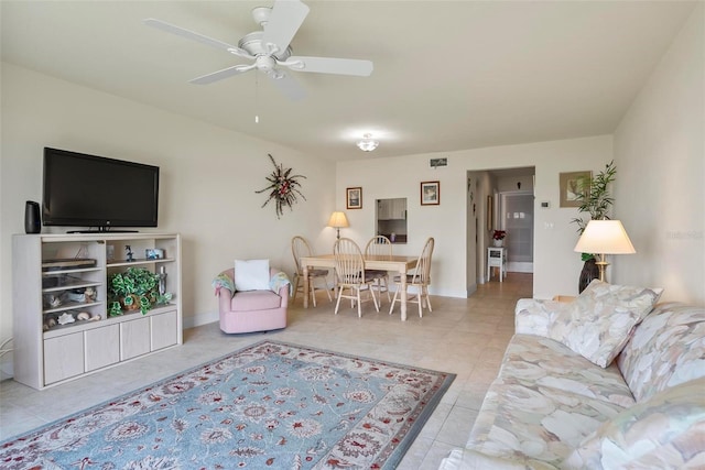 tiled living room with ceiling fan