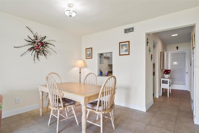 dining area featuring light tile patterned floors