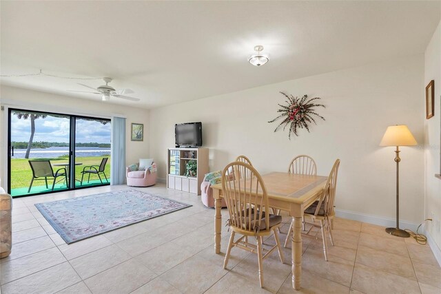 tiled dining space with ceiling fan