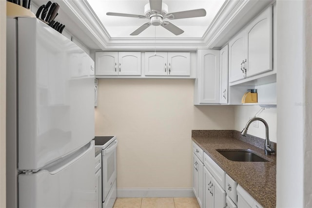 kitchen featuring a tray ceiling, sink, white cabinets, and white appliances