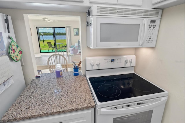 kitchen featuring white cabinets and white appliances