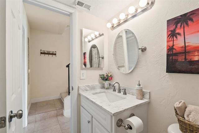 bathroom featuring tile patterned floors, vanity, and toilet