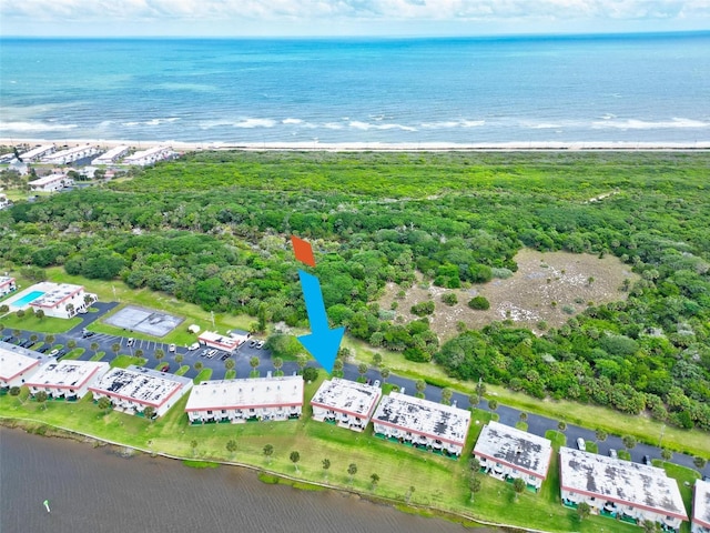 drone / aerial view with a water view and a view of the beach