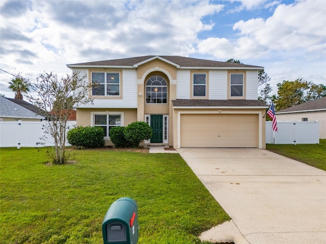 view of property featuring a front yard and a garage