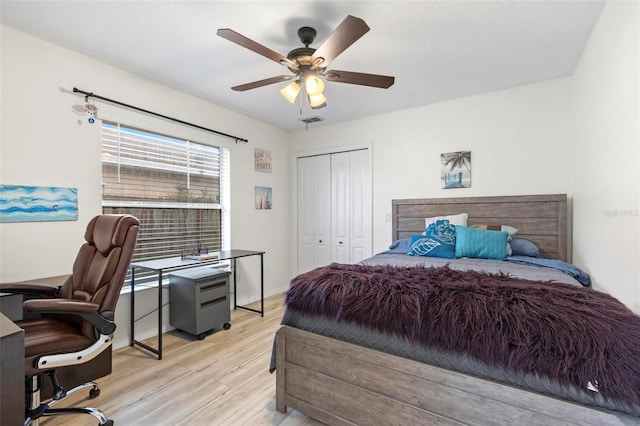 bedroom with ceiling fan, a closet, and light hardwood / wood-style flooring