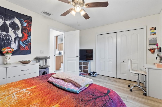 bedroom with a closet, ceiling fan, and light wood-type flooring