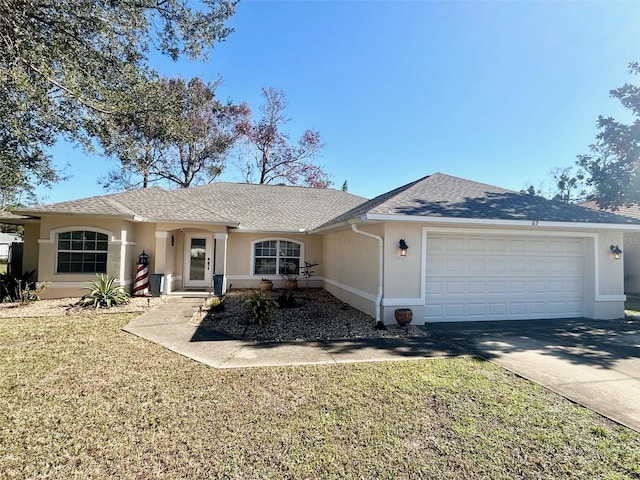 single story home featuring a garage and a front lawn