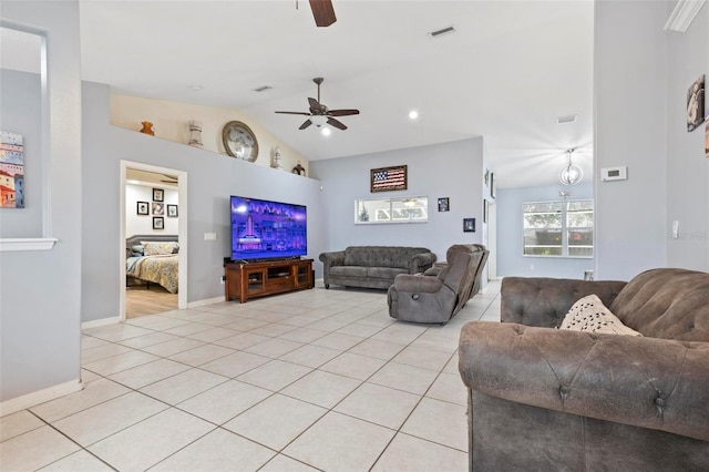 tiled living room with ceiling fan and vaulted ceiling