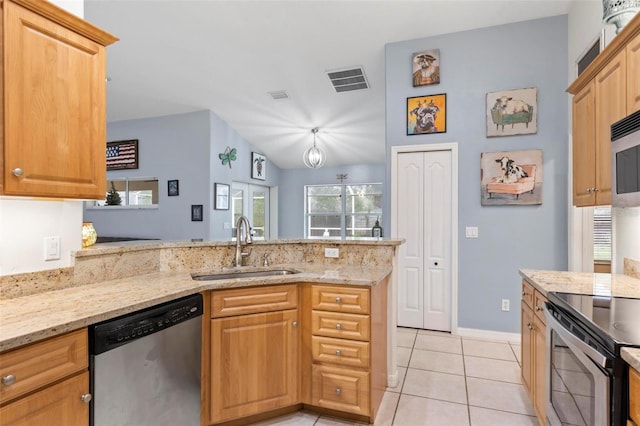 kitchen featuring sink, light stone countertops, kitchen peninsula, and appliances with stainless steel finishes