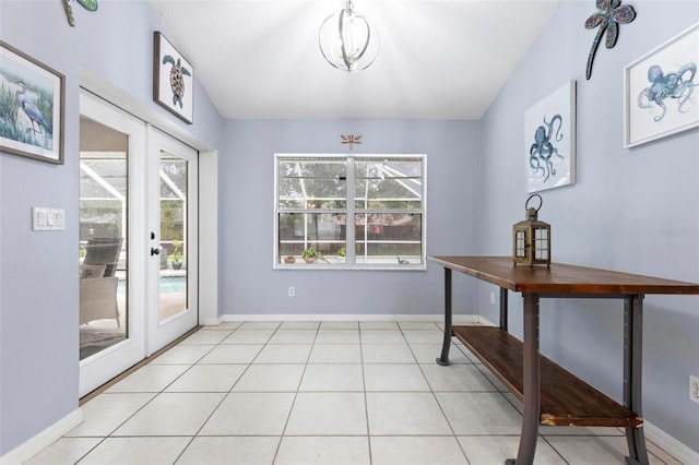 doorway to outside featuring french doors, a healthy amount of sunlight, and light tile patterned flooring