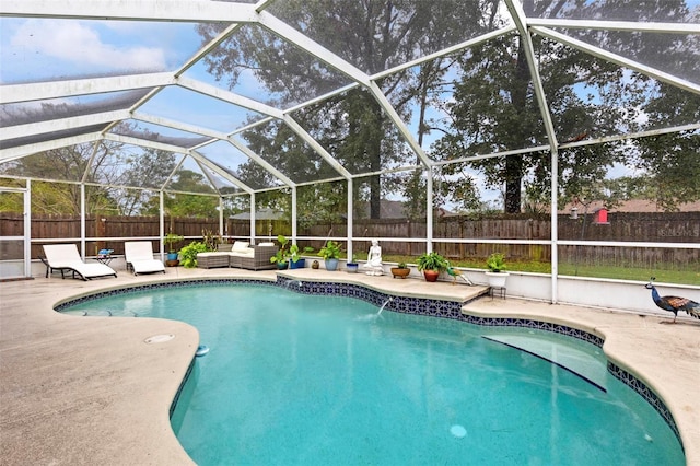 view of pool with an outdoor living space, a patio, and a lanai