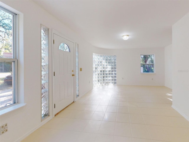 entryway with plenty of natural light and light tile patterned flooring