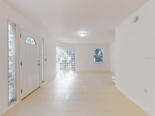 entryway featuring plenty of natural light and light tile patterned flooring