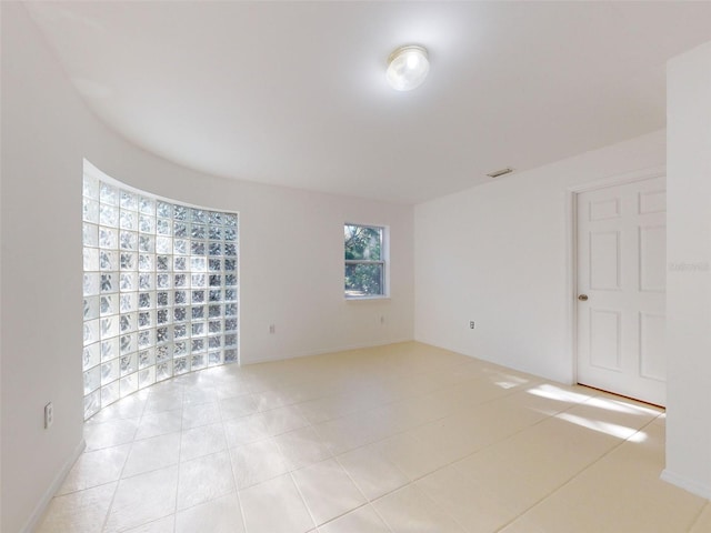 spare room featuring light tile patterned floors