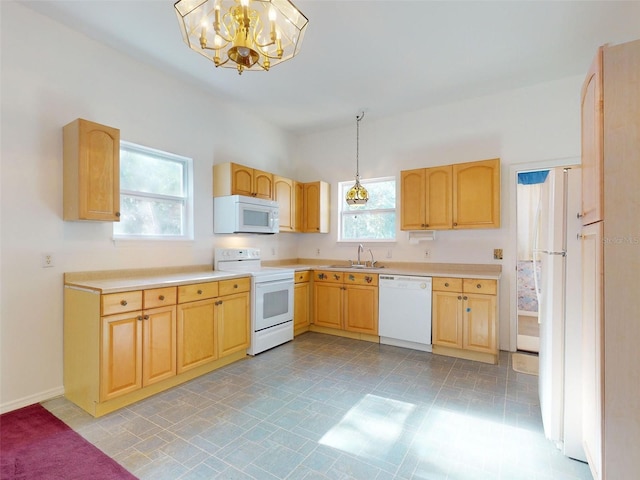 kitchen with white appliances, decorative light fixtures, and a healthy amount of sunlight