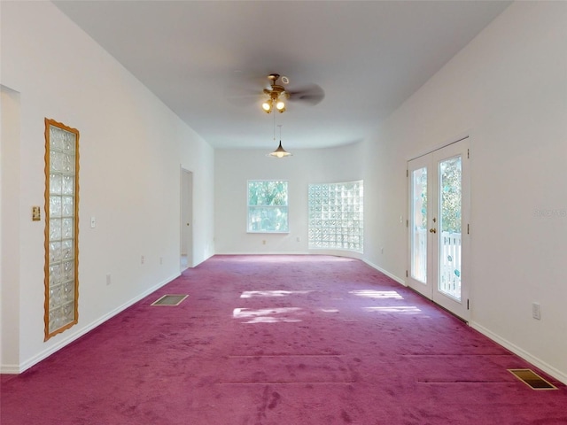 carpeted empty room with french doors and ceiling fan