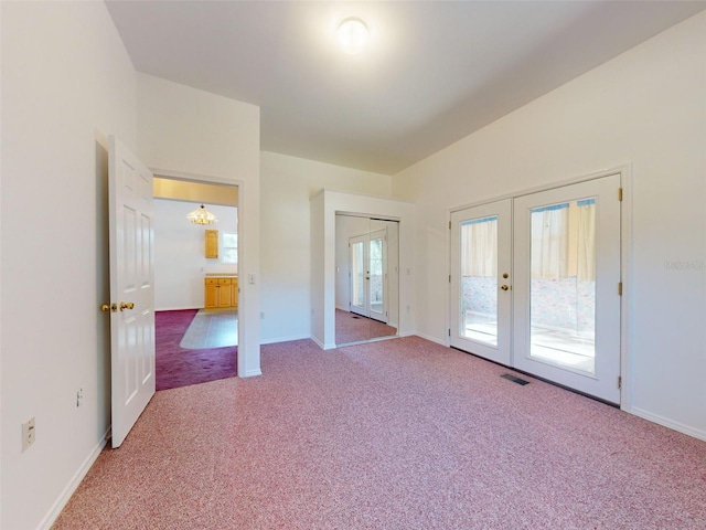 empty room featuring french doors and carpet floors