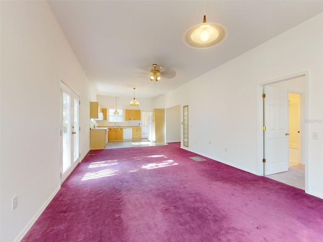 unfurnished living room with light colored carpet, ceiling fan, and sink