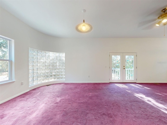 spare room with ceiling fan, french doors, and carpet