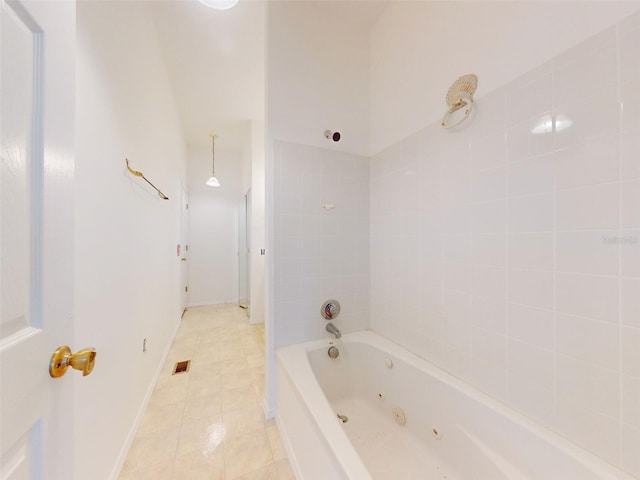 bathroom featuring tile patterned flooring and tiled shower / bath combo