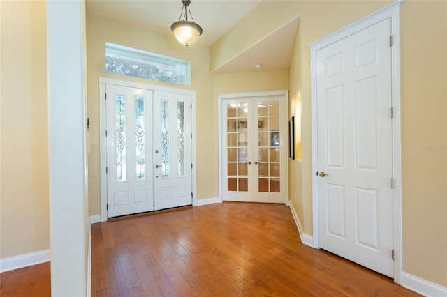 entryway featuring french doors and hardwood / wood-style flooring