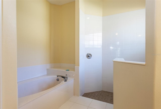 bathroom with tile patterned floors and shower with separate bathtub