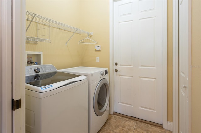 laundry area featuring separate washer and dryer and light tile patterned floors