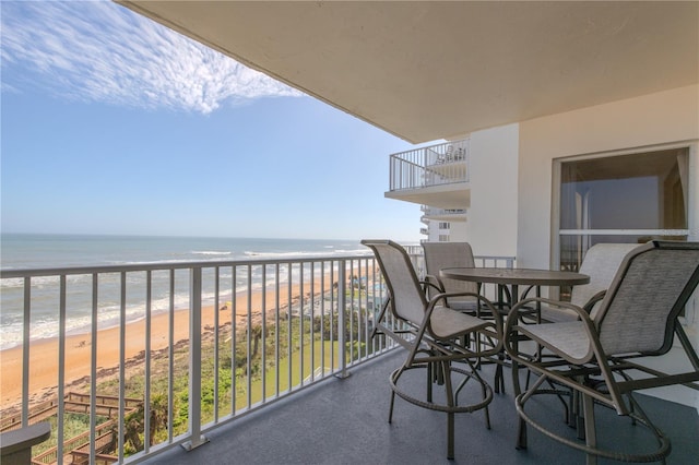 balcony with a water view and a beach view