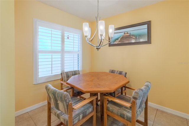 tiled dining space with a notable chandelier